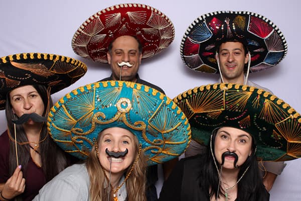 An image of a bunch of people wearing sombreros posing in front of our white tension backdrop